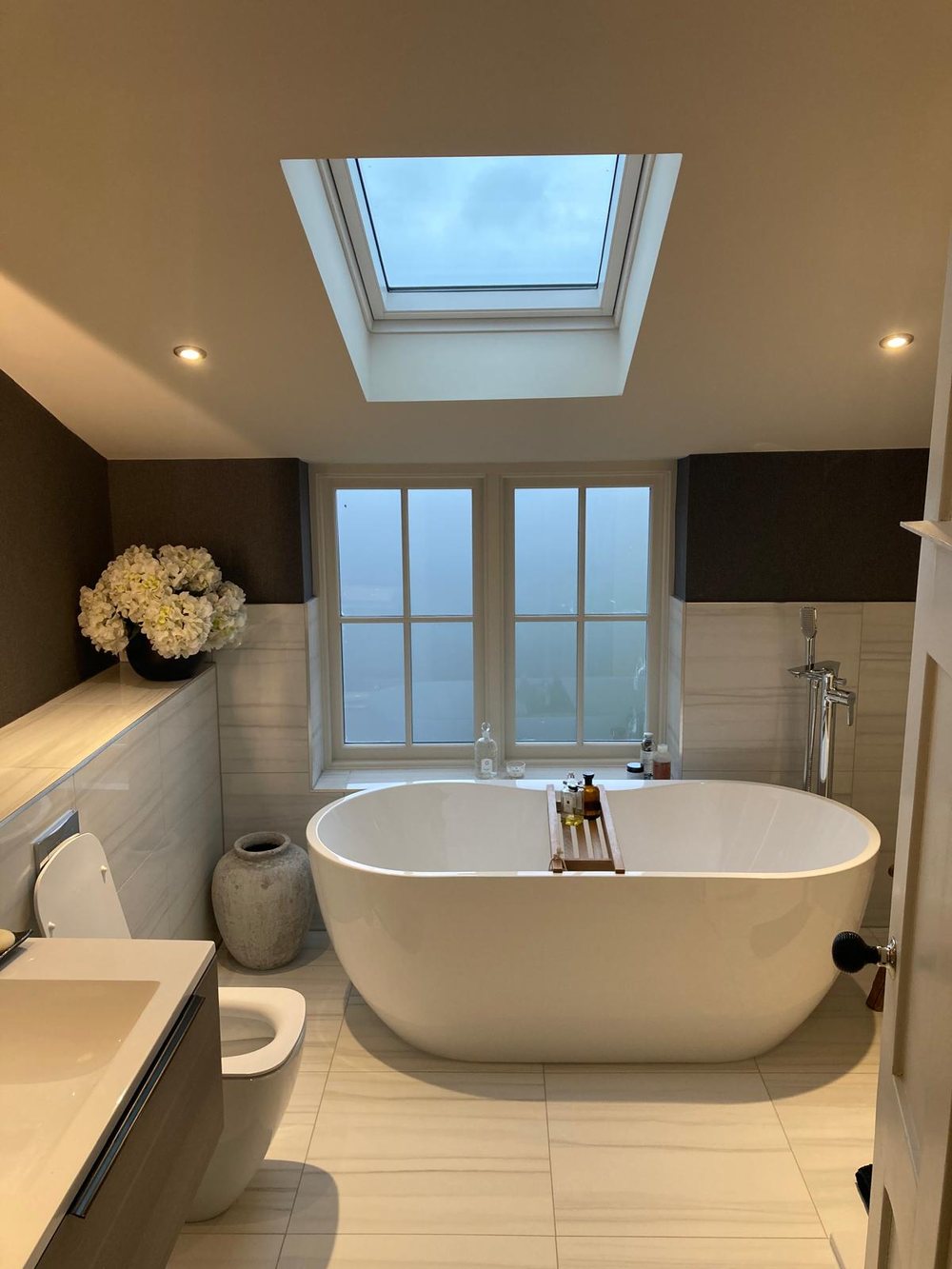 Freestanding bath under a window, fitted by GPH Plumbing & Heating