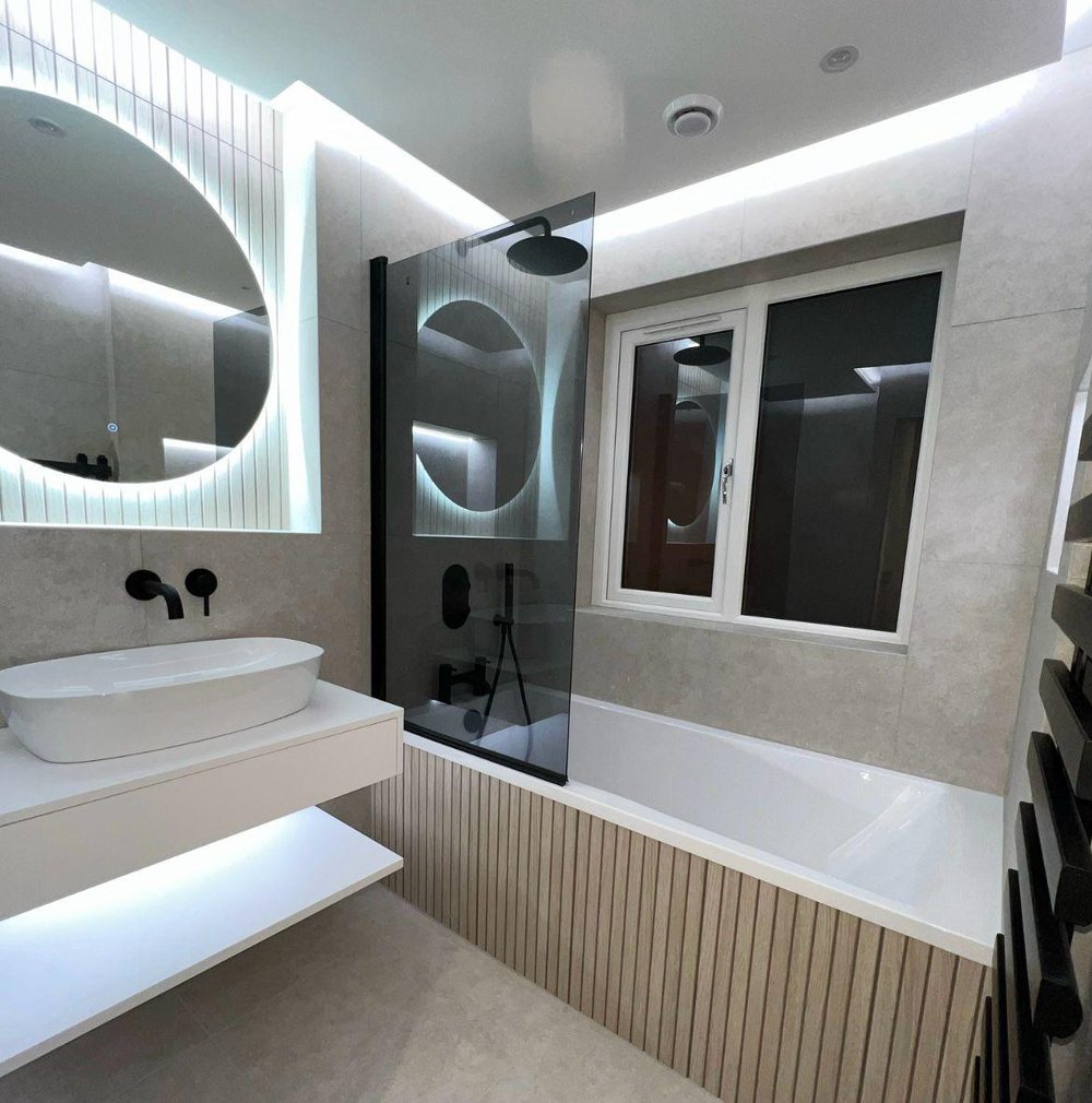 Oak slatted bath panel with a round LED mirror